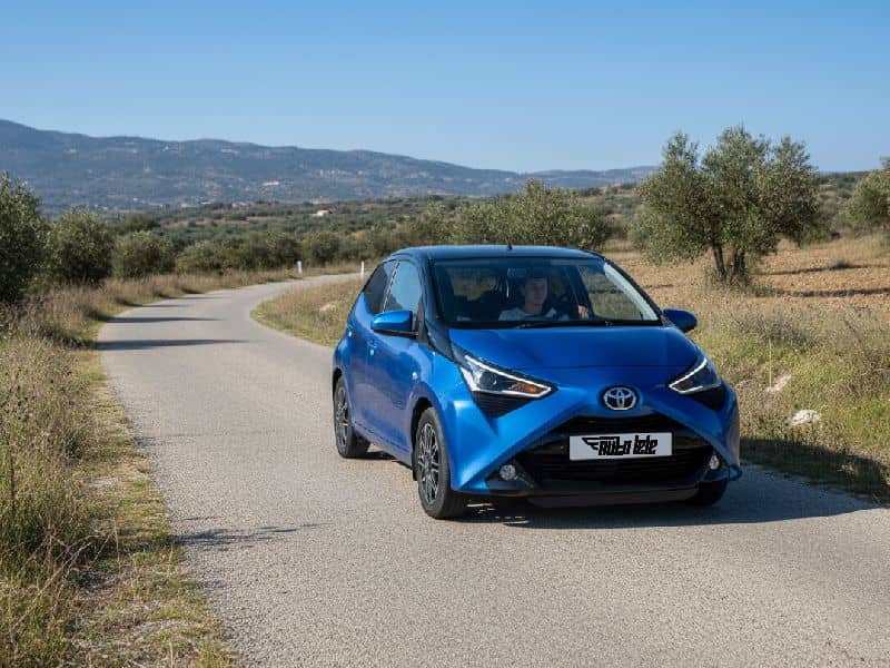 Compact rental car driving through the countryside of Crete